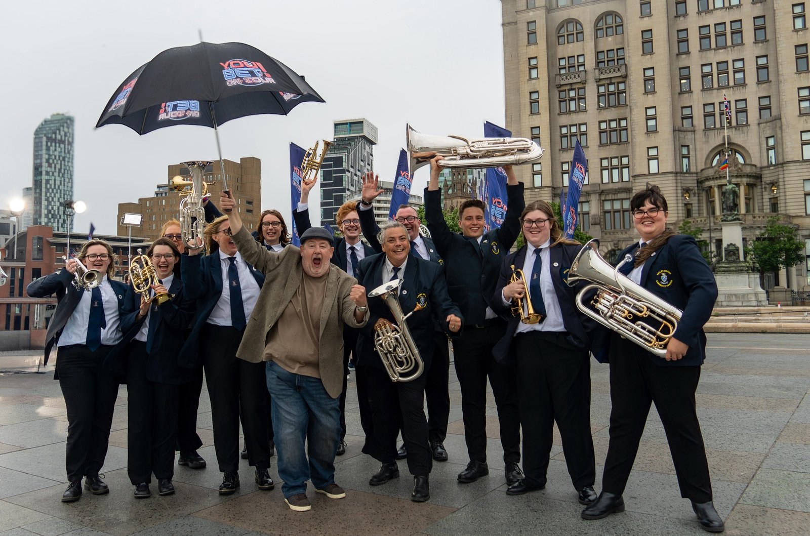 Valley Brass Band posing with St. Helens comedian Johnny Vegas
