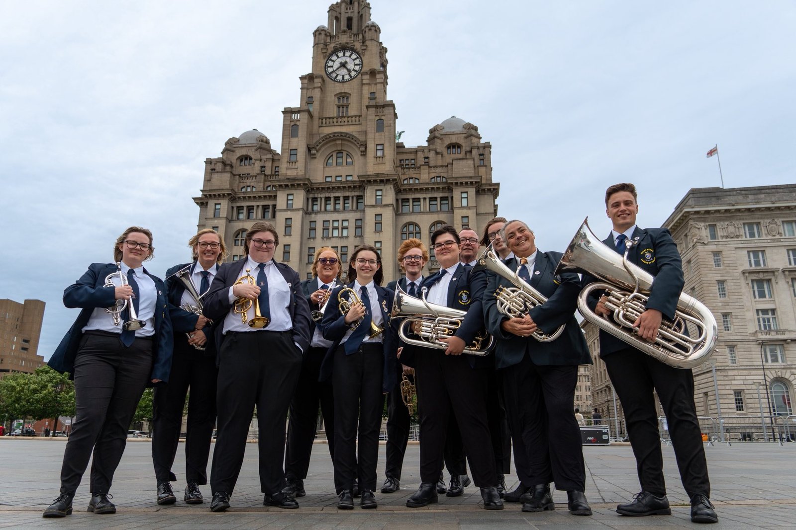 Valley Brass Band performing in front of the Royal Liver Building in Liverpool